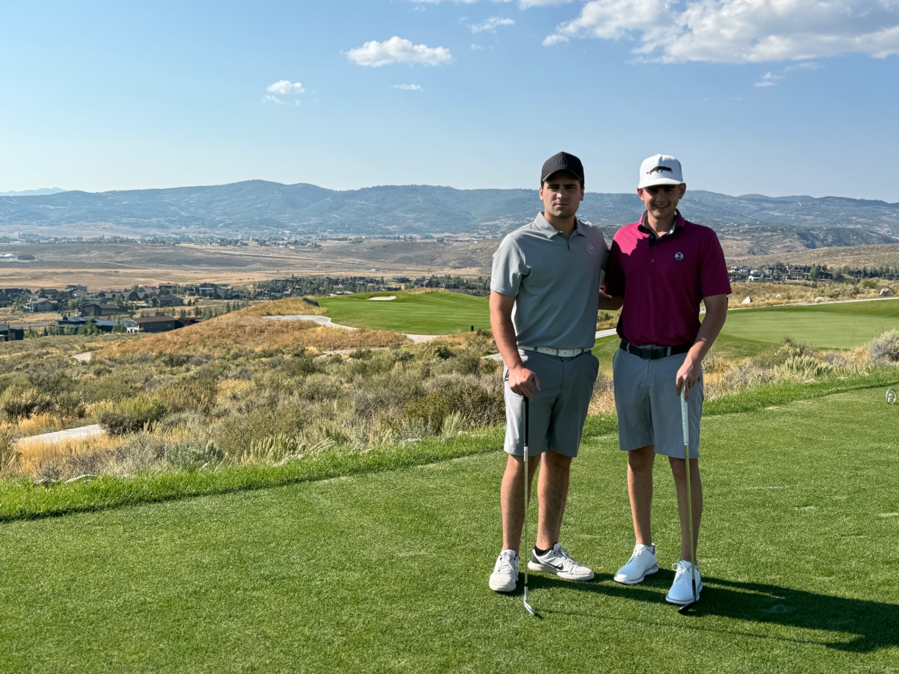 Enzo Toledo and Gavin Sperber, the founders of FirstTee, on a mountain-view golf course tee box